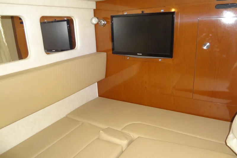 Slide: The Image of Interior of 2013 Sea Ray Sundancer 330 with beige seating and wall-mounted TV. - 48