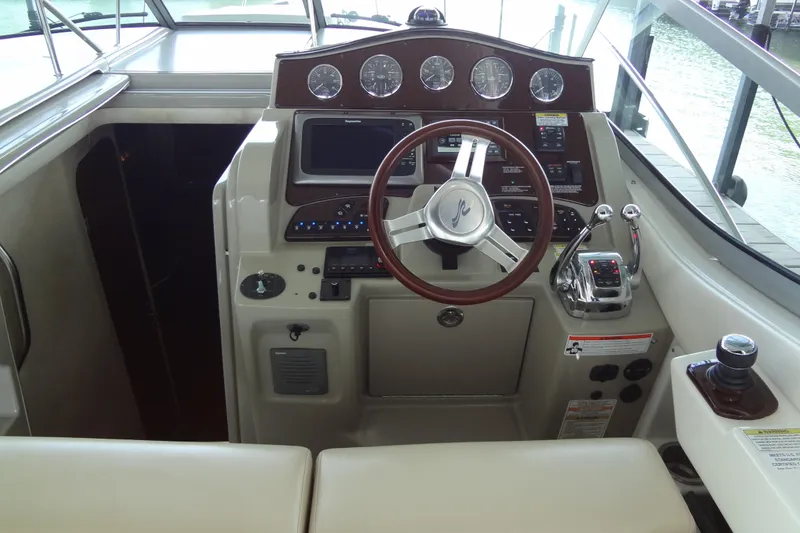 Slide: The Image of 2013 Sea Ray Sundancer 330 helm with steering wheel and control panel. - 25