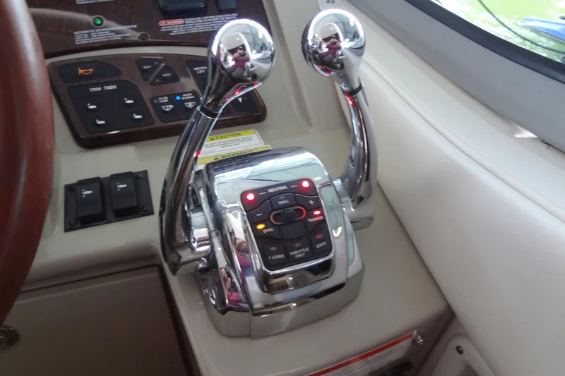 Slide: The Image of Control panel of a 2013 Sea Ray Sundancer 330 boat with dual throttle levers. - 31