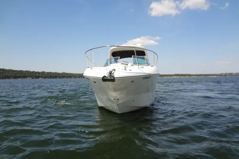 Slide: The Image of 2013 Sea Ray Sundancer 330 cruising on a sunny day, surrounded by calm waters. - 11
