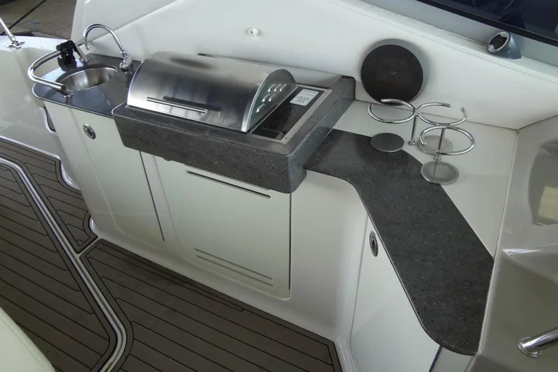 Slide: The Image of Outdoor kitchen area on 2013 Sea Ray Sundancer 330 yacht with grill and sink. - 23