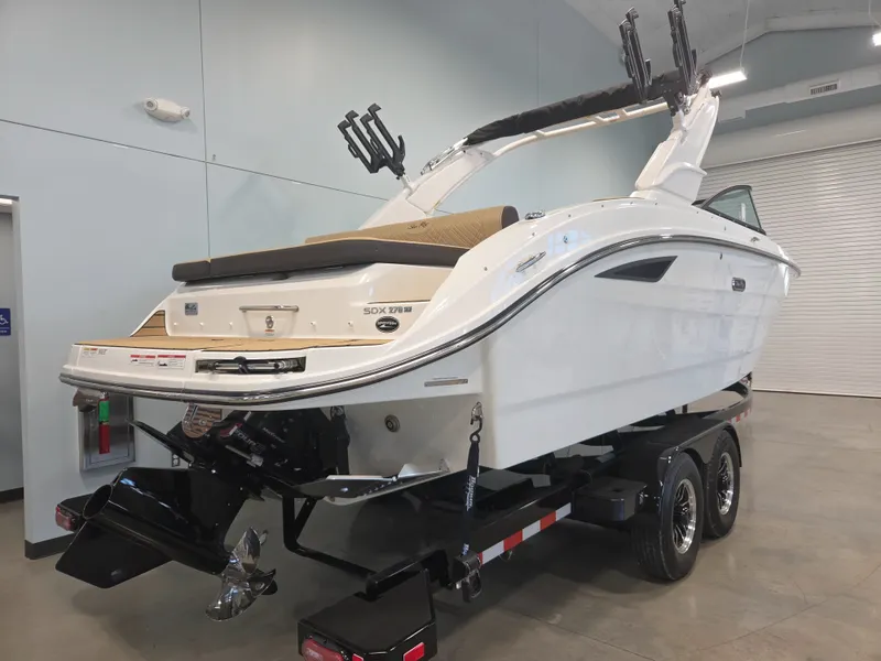 Slide: The Image of A 2027 Sea Ray SDX 270 Surf on a trailer inside a warehouse. - 4