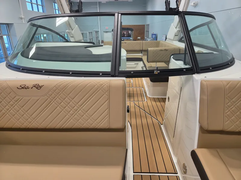 Slide: The Image of The image shows the interior of a Sea Ray SDX 270 Surf boat with beige seats and wood flooring. - 29