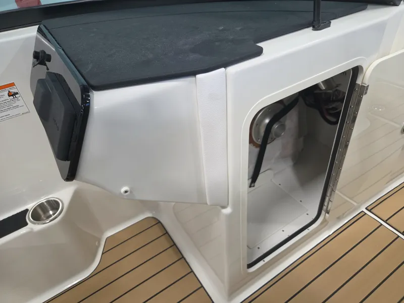 Slide: The Image of The image shows the interior of a Sea Ray SDX 270 Surf boat with storage space. - 24