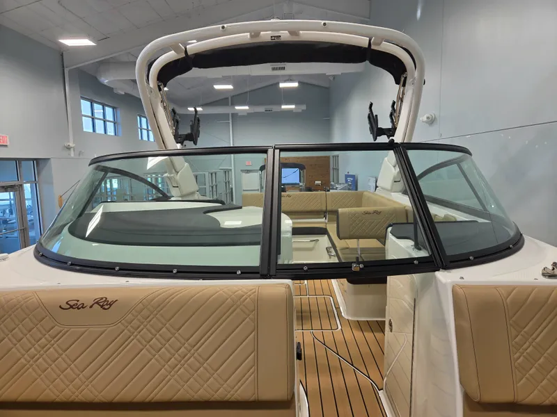 Slide: The Image of Interior view of a 2027 Sea Ray SDX 270 Surf with beige seats and wooden flooring. - 30