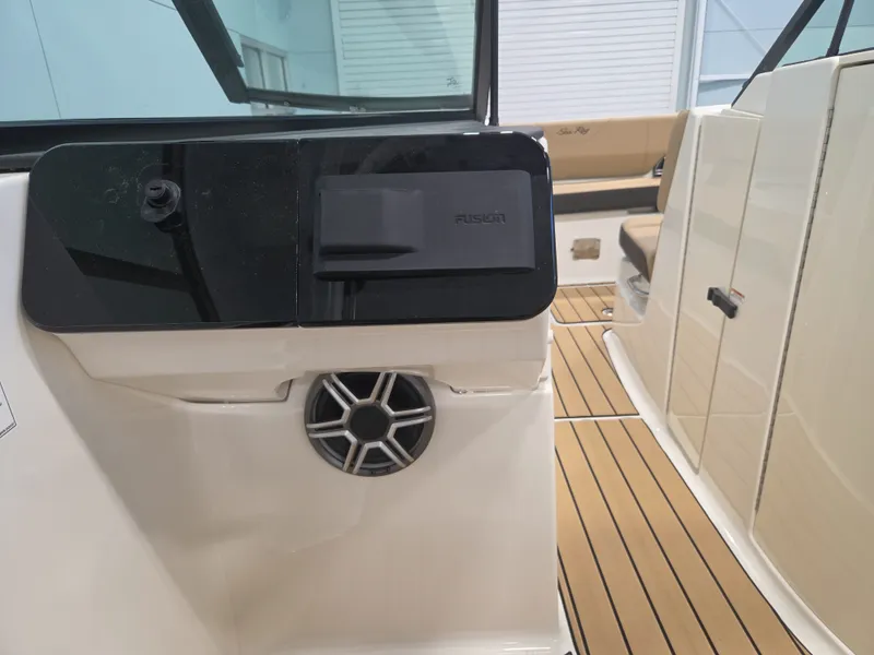 Slide: The Image of The image shows the interior of a 2027 Sea Ray SDX 270 Surf with sleek seating and a speaker. - 20
