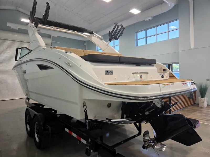 Slide: The Image of The image shows a 2027 Sea Ray SDX 270 Surf boat in a showroom. - 3