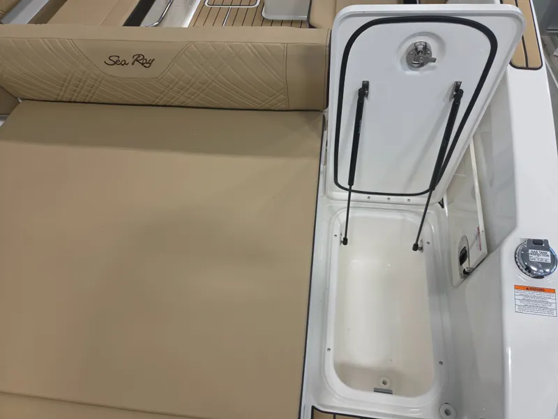 Slide: The Image of The image shows the deck of a 2027 Sea Ray SDX 270 Surf with an open storage compartment. - 37