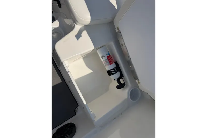 Slide: The Image of 2024 Tahoe T16 boat storage compartment with fire extinguisher. - 12