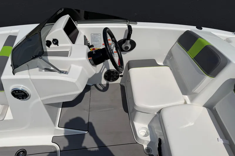 Slide: The Image of 2024 Tahoe T16 boat interior with steering wheel, seating, and dashboard controls. - 11