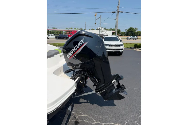 Slide: The Image of 2024 Tahoe T16 boat with Mercury outboard motor in a parking lot. - 10