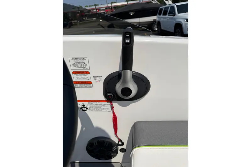 Slide: The Image of Throttle control panel of 2024 Tahoe T16 boat with safety warnings and red lanyard. - 14