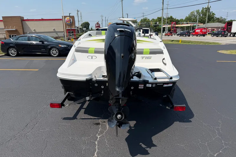 Slide: The Image of 2024 Tahoe T16 boat with outboard motor in a parking lot. - 3