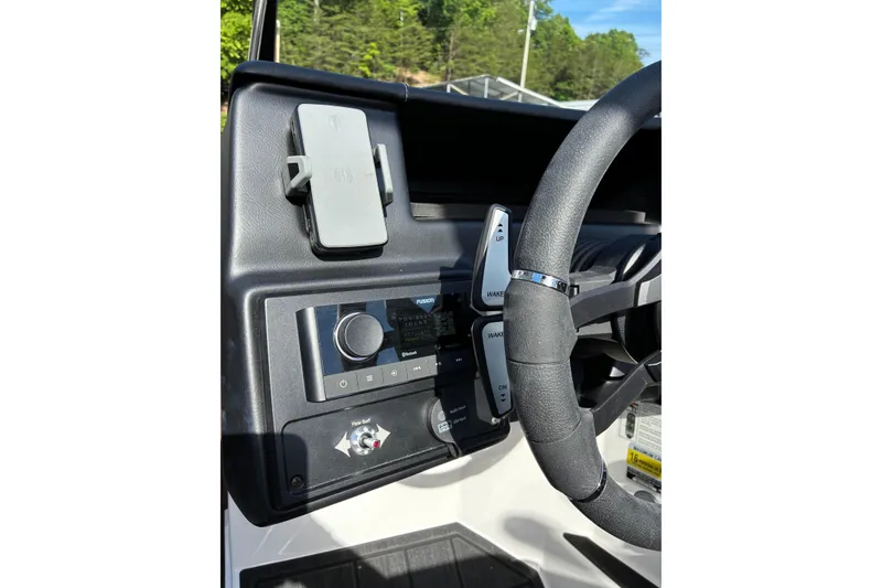 Slide: The Image of 2025 Moomba Max dashboard with steering wheel, control panel, and phone holder. - 30