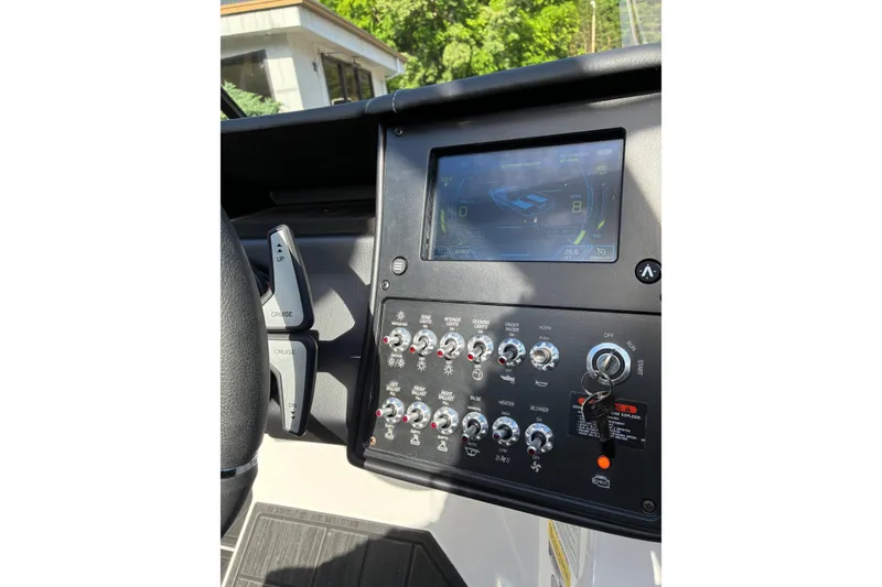 Slide: The Image of 2025 Moomba Max dashboard with touchscreen display and control switches. - 31