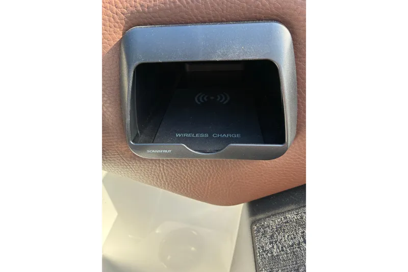 Slide: The Image of 2025 Moomba Max wireless charging station with brown leather trim. - 33