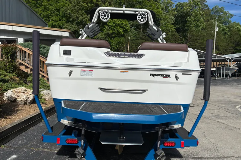 Slide: The Image of 2025 Moomba Max boat with Raptor engine, displayed on a trailer in a sunny outdoor setting. - 5