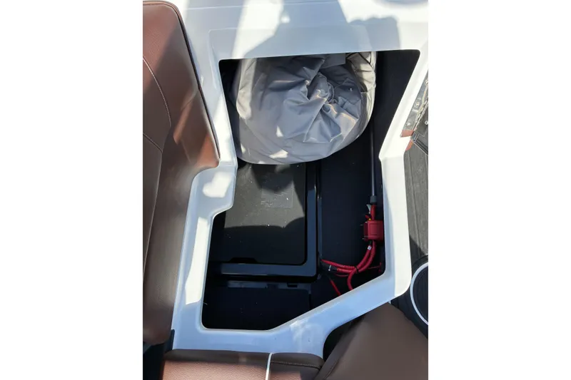 Slide: The Image of 2025 Moomba Max boat interior storage compartment with cover and wiring. - 27