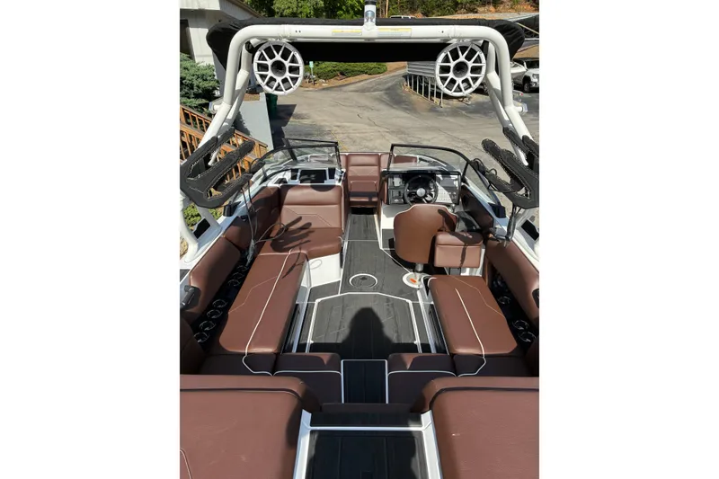 Slide: The Image of 2025 Moomba Max boat interior with brown seating and modern dashboard. - 10