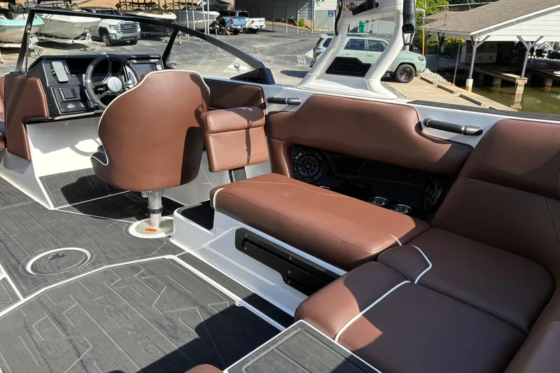 Slide: The Image of 2025 Moomba Max boat interior with brown leather seating and modern dashboard design. - 19
