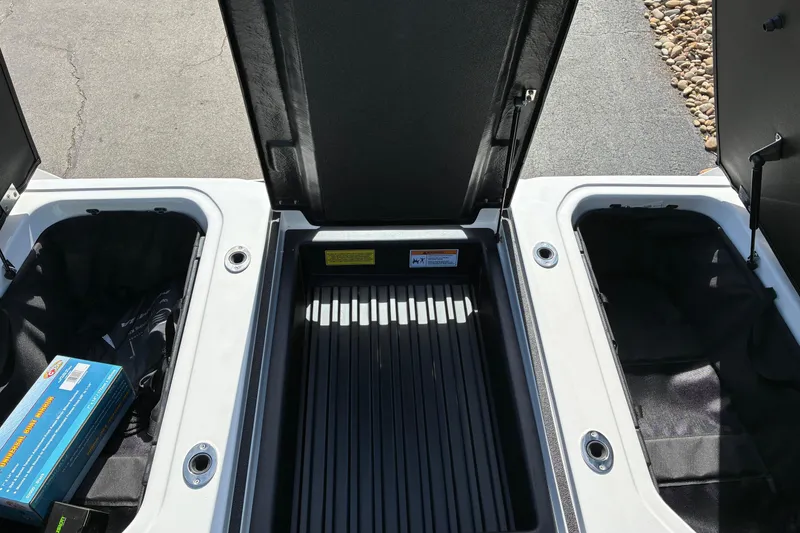 Slide: The Image of 2025 Moomba Max boat storage compartments with open lids, showcasing ample space. - 14