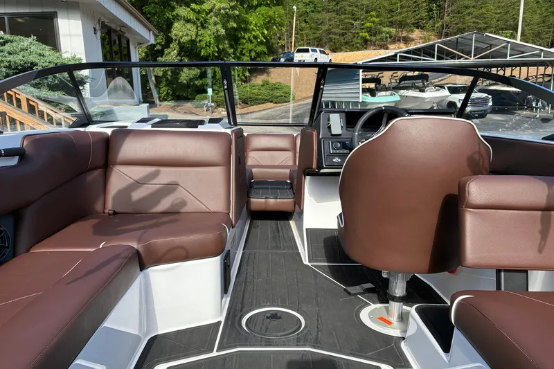 Slide: The Image of Interior of 2025 Moomba Max boat with brown seating and modern dashboard. - 45