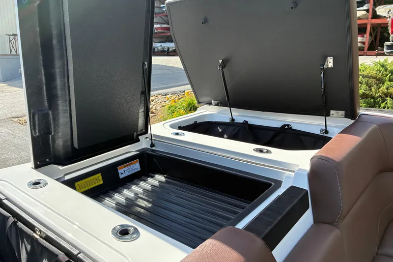 Slide: The Image of 2025 Moomba Max boat storage compartments open, showcasing spacious interior design. - 13