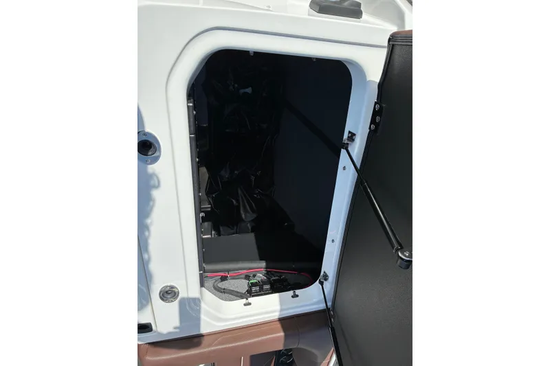 Slide: The Image of Open storage compartment in 2025 Moomba Max boat, showcasing interior space and design. - 15