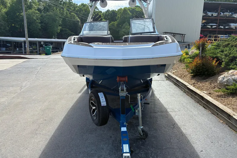 Slide: The Image of 2025 Moomba Max boat on trailer, parked outdoors near marina. - 1