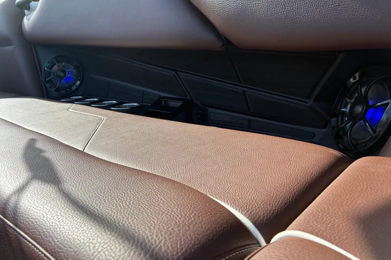 Slide: The Image of Close-up of a brown leather seat with built-in speakers and blue lighting. - 20