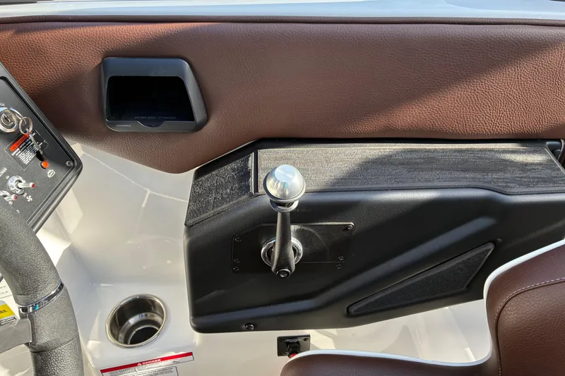 Slide: The Image of 2025 Moomba Max boat interior dashboard with controls and steering wheel. - 32