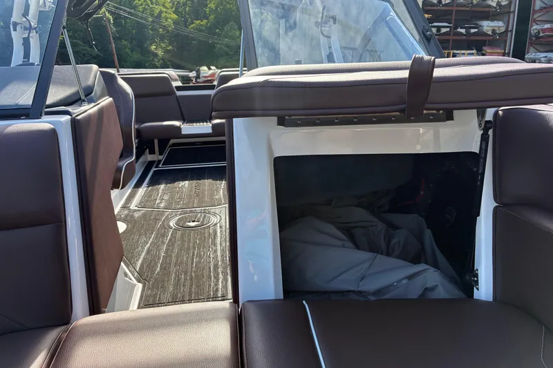 Slide: The Image of Interior of 2025 Moomba Max boat with brown seating and storage compartment. - 41