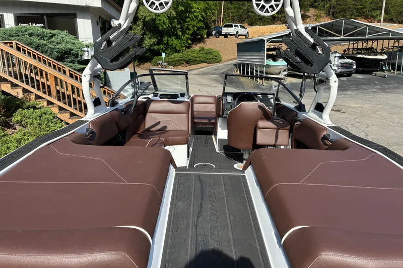 Slide: The Image of 2025 Moomba Max boat interior with brown seating and modern design. - 11