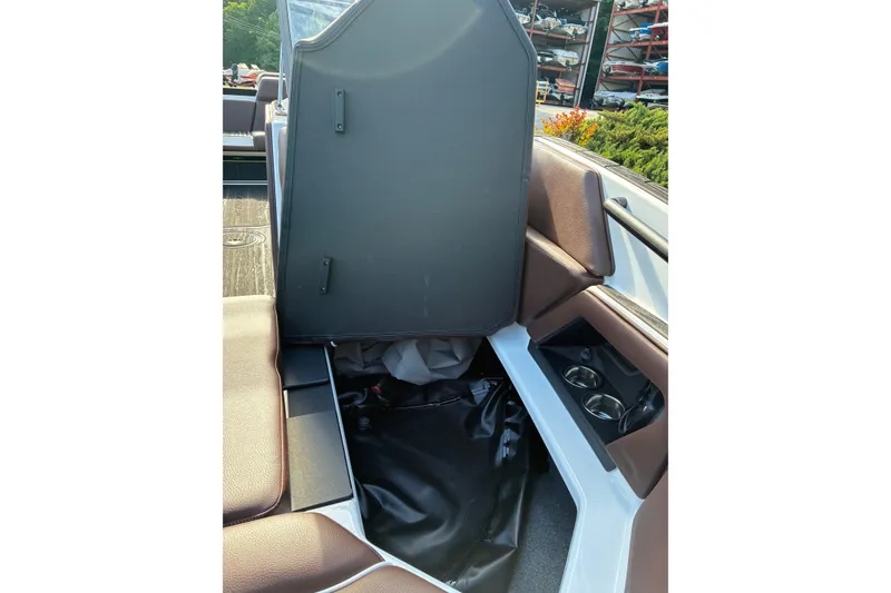 Slide: The Image of 2025 Moomba Max boat interior with storage compartment and cup holders. - 40