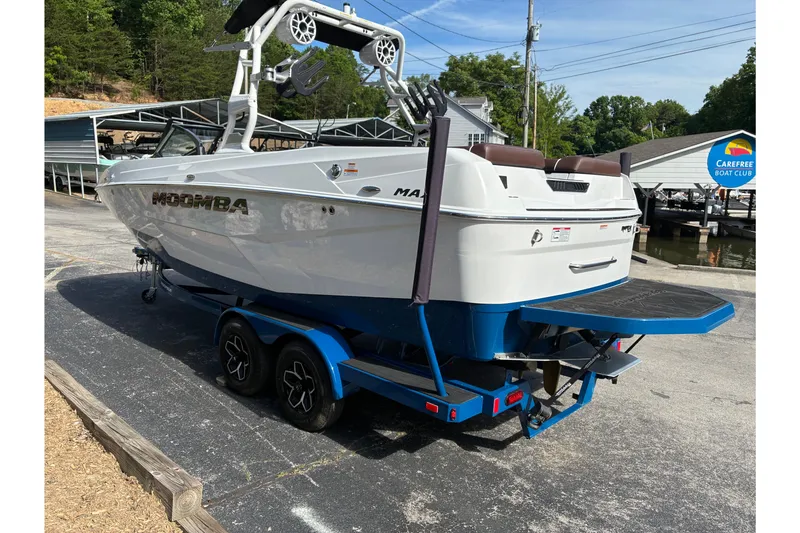 Slide: The Image of 2025 Moomba Max boat on trailer at marina, featuring sleek design and vibrant blue accents. - 6