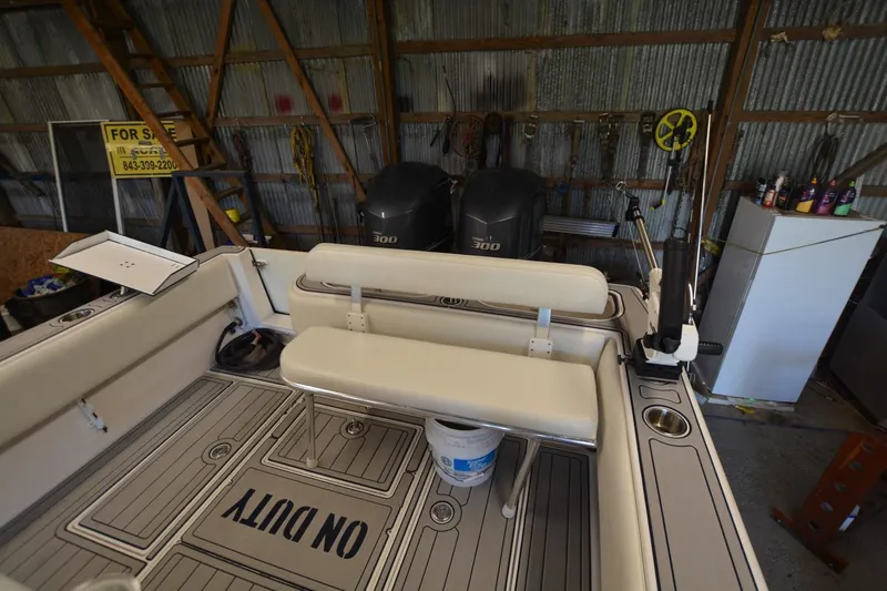 Slide: The Image of 2005 Contender 31 Open boat interior with dual engines in a garage setting. - 15