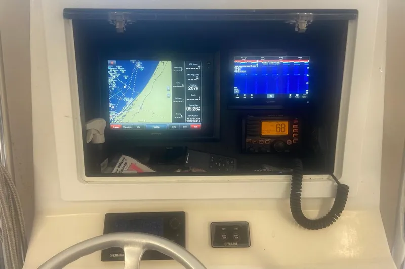 Slide: The Image of Dashboard of a 2005 Contender 31 Open boat with navigation and communication equipment. - 13
