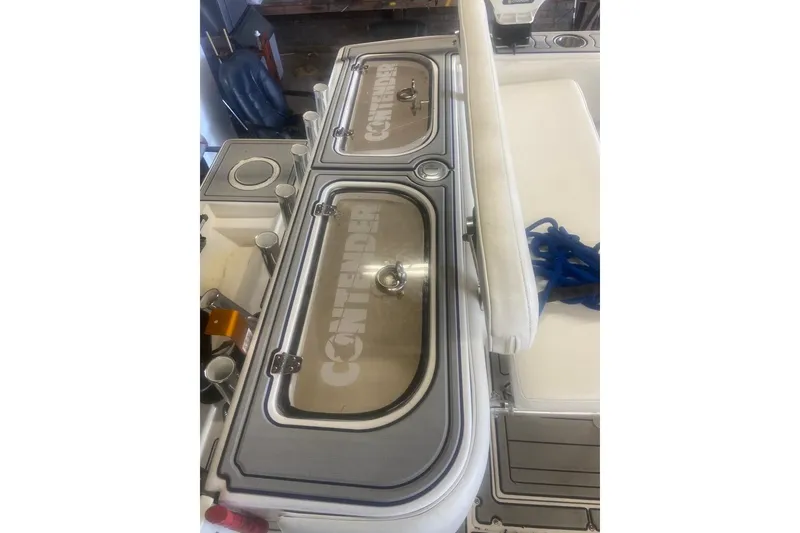 Slide: The Image of 2005 Contender 31 Open boat deck with storage compartments and blue rope. - 26