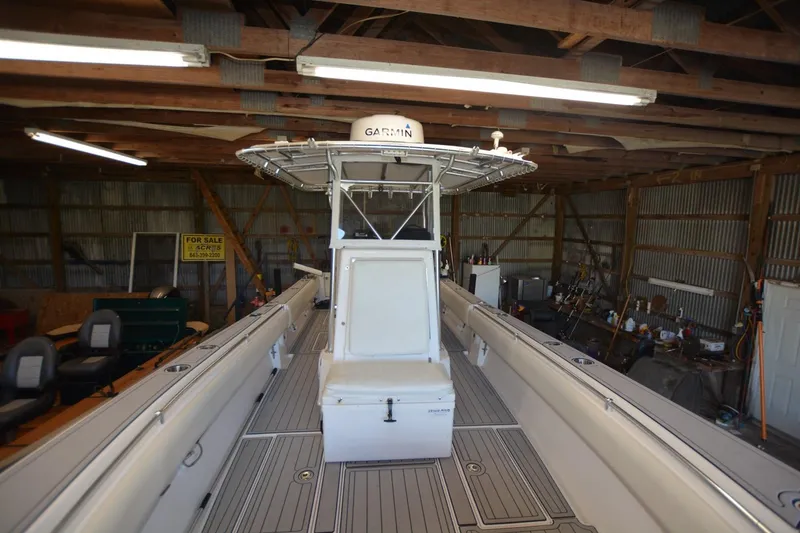 Slide: The Image of 2005 Contender 31 Open boat in a wooden garage, featuring Garmin equipment. - 10