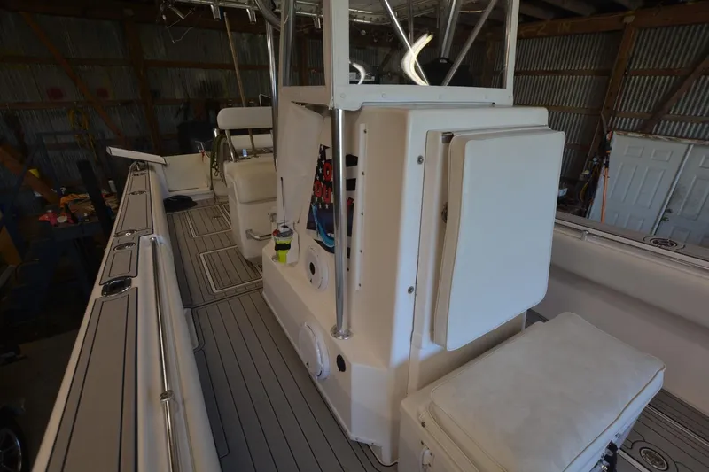 Slide: The Image of 2005 Contender 31 Open boat interior with seating and storage in a garage setting. - 11