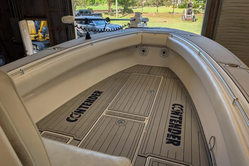 Slide: The Image of 2005 Contender 31 Open boat interior with branded flooring in a garage setting. - 30