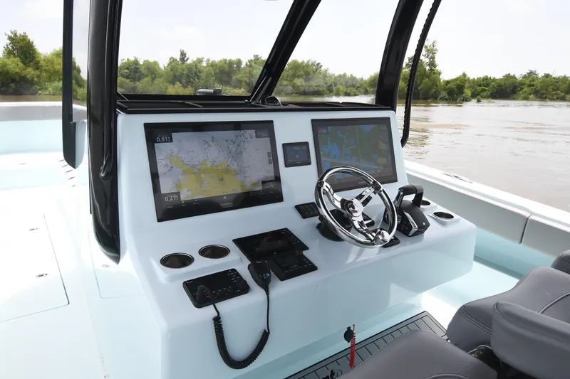 Slide: The Image of 2024 Front Runner 37 Catamaran helm with advanced navigation displays and controls. - 13