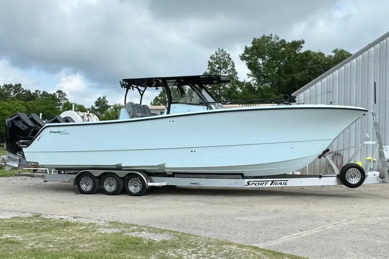 Slide: The Image of 2024 Front Runner 37 Catamaran on trailer, parked outdoors, showcasing sleek design and powerful engines. - 11
