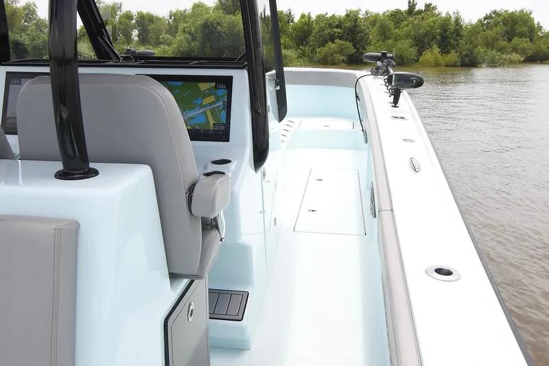 Slide: The Image of 2024 Front Runner 37 Catamaran interior with navigation screens, sleek design, and water view. - 18