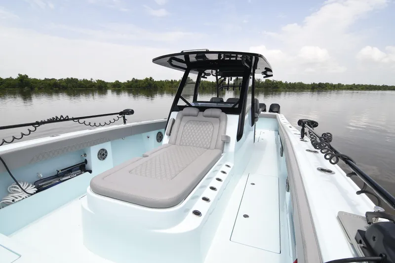Slide: The Image of 2024 Front Runner 37 Catamaran on calm water, featuring sleek design and comfortable seating. - 12