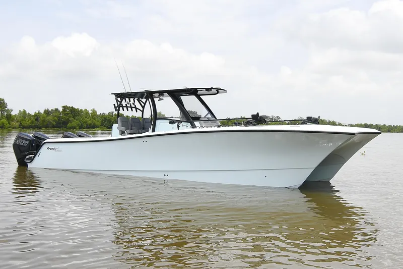 Slide: The Image of 2024 Front Runner 37 Catamaran on calm water, showcasing sleek design and powerful engines. - 4