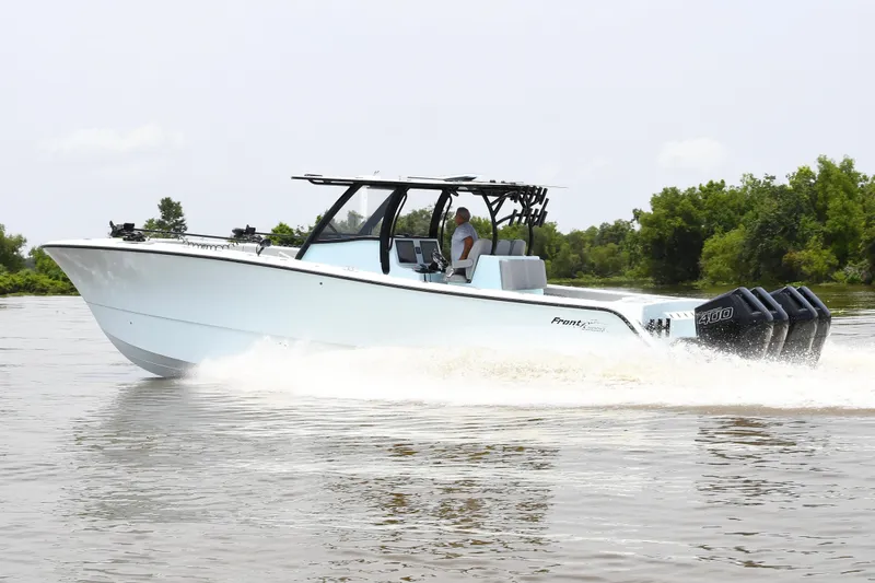 Slide: The Image of 2024 Front Runner 37 Catamaran cruising on a river with lush greenery. - 10
