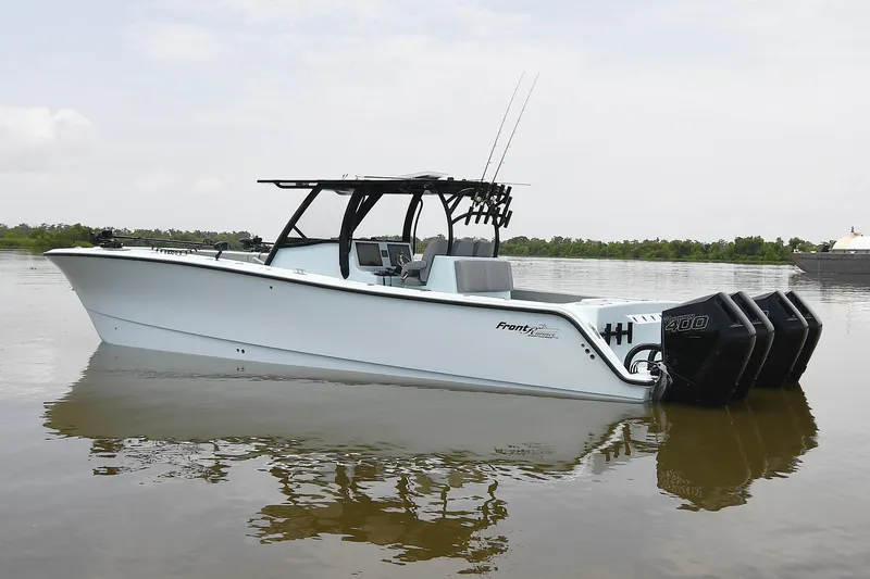 Slide: The Image of 2024 Front Runner 37 Catamaran with triple engines on calm water. - 3