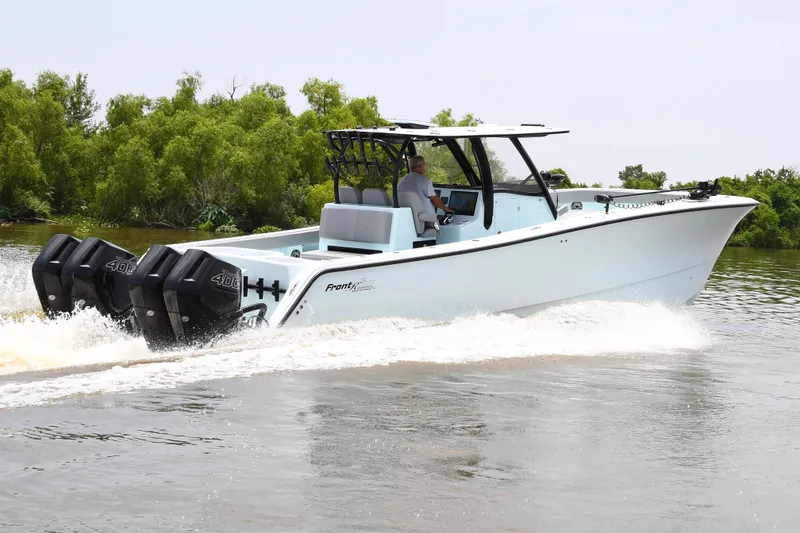 Slide: The Image of 2024 Front Runner 37 Catamaran cruising on water with triple outboard engines. - 6