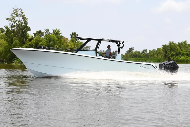 Slide: The Image of 2024 Front Runner 37 Catamaran cruising on a river with lush greenery in the background. - 2
